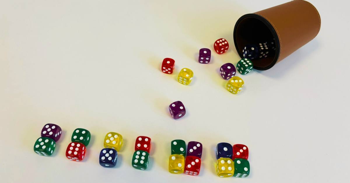 Würfelbecher mit bunten Würfeln, wo zwei Würfel immer 10 ergeben